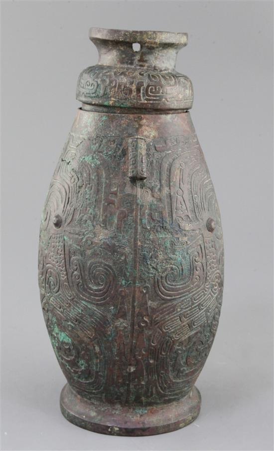 A Chinese archaic bronze ritual drinking vessel and cover, Hu, Western Zhou dynasty, 11th-9th century B.C., 30cm high, faults